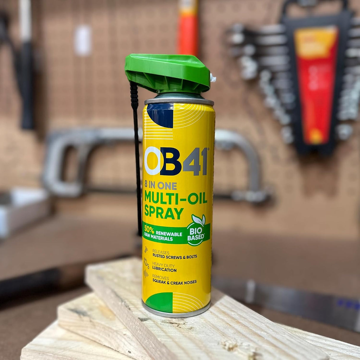 OB41 multi-oil spray can on a wooden surface with a workshop background