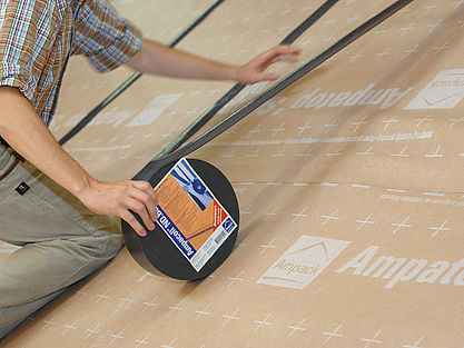 Person installing with ampacoll ND band tape