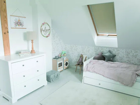 cream manual roller blind in bedroom