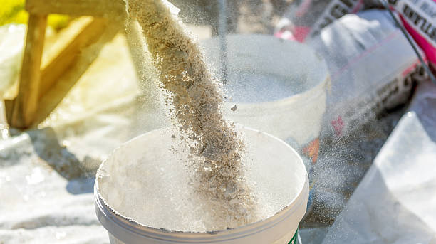 Pouring plaster into a bucket picture